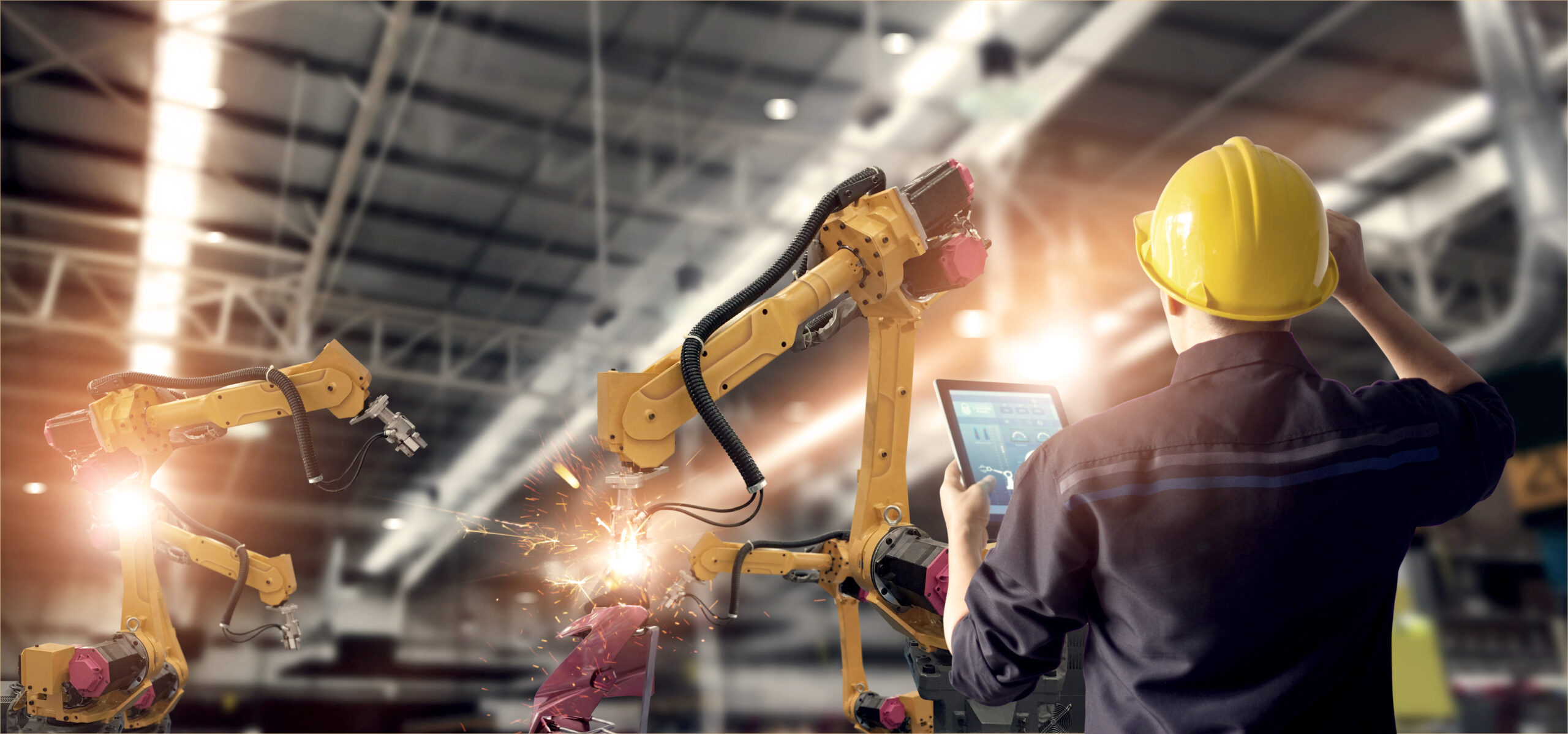 Engineer Using Tablet Check And Control Automation Robot Arms Machine In Intelligent Factory Industrial On Monitoring System Software. Welding Robotics And Digital Manufacturing Operation.